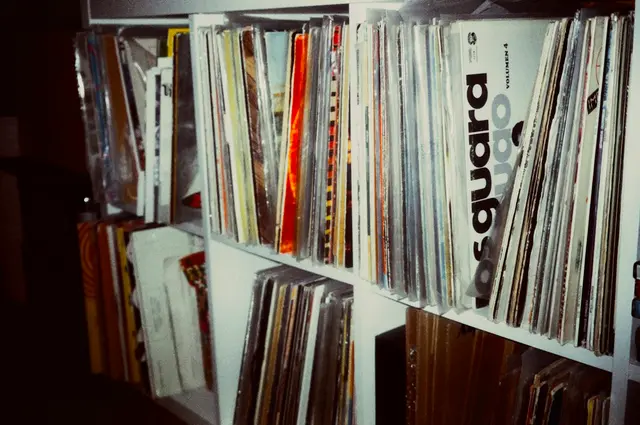 White KALLAX cube shelving packed with LPs standing upright, seen close up at an angle