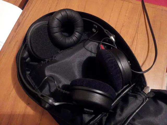 Sennheiser HD 25-1 II headphones in an open zip case, with black velour ear pads and a leather ear pad